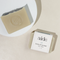 A bar of Aide Bodycare Eucalyptus Mint Soap, featuring a light beige color and a paper label with the 'aide' logo and 'Eucalyptus Mint' text, displayed on a light-colored surface with a shadow overlay. The soap is natural and handmade, available in Mississippi Mills, Ontario, Canada.