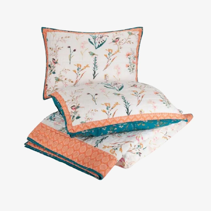 An image of a floral quilt set and two pillows.