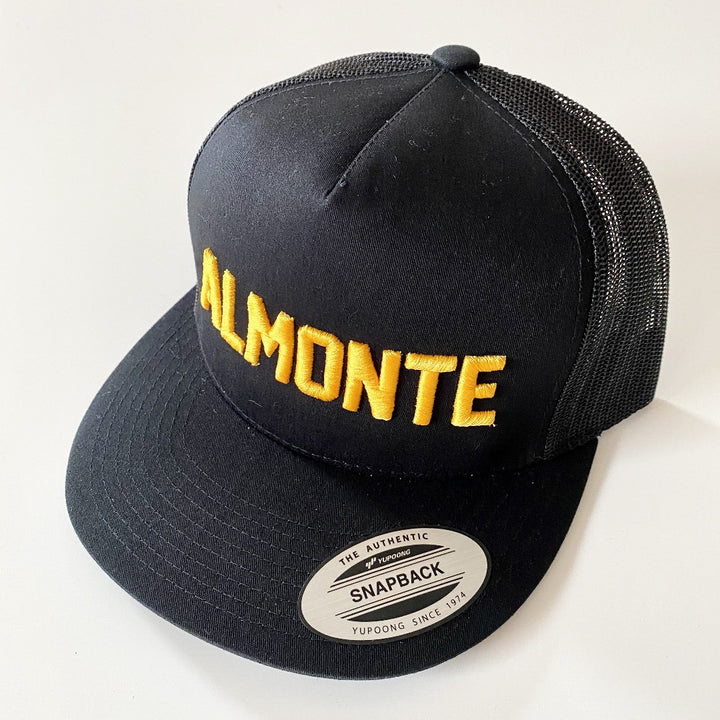 Black trucker hat with Almonte embroidered in gold on front