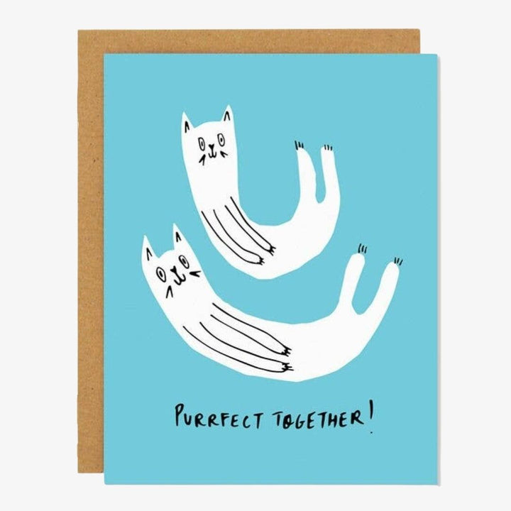 A blue card with two white cats and quote 