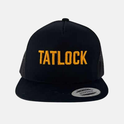 Black trucker hat with Tatlock embroidered in gold on front.
