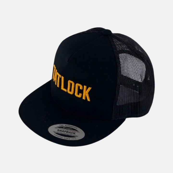 Black trucker hat with Tatlock embroidered in gold on front.