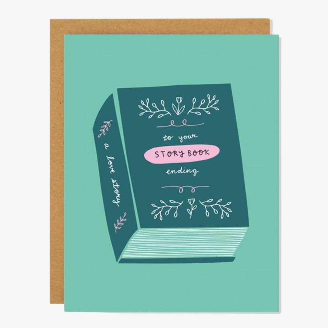 A teal card with a book titled "A love story, to your story book ending"