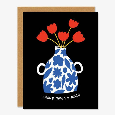 A black card with a white and blue vase with red flowers and the quote 