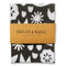 A black and white geometric floral tea towel in brown packaging that says Badger & Burke, 100% cotton tea towel.