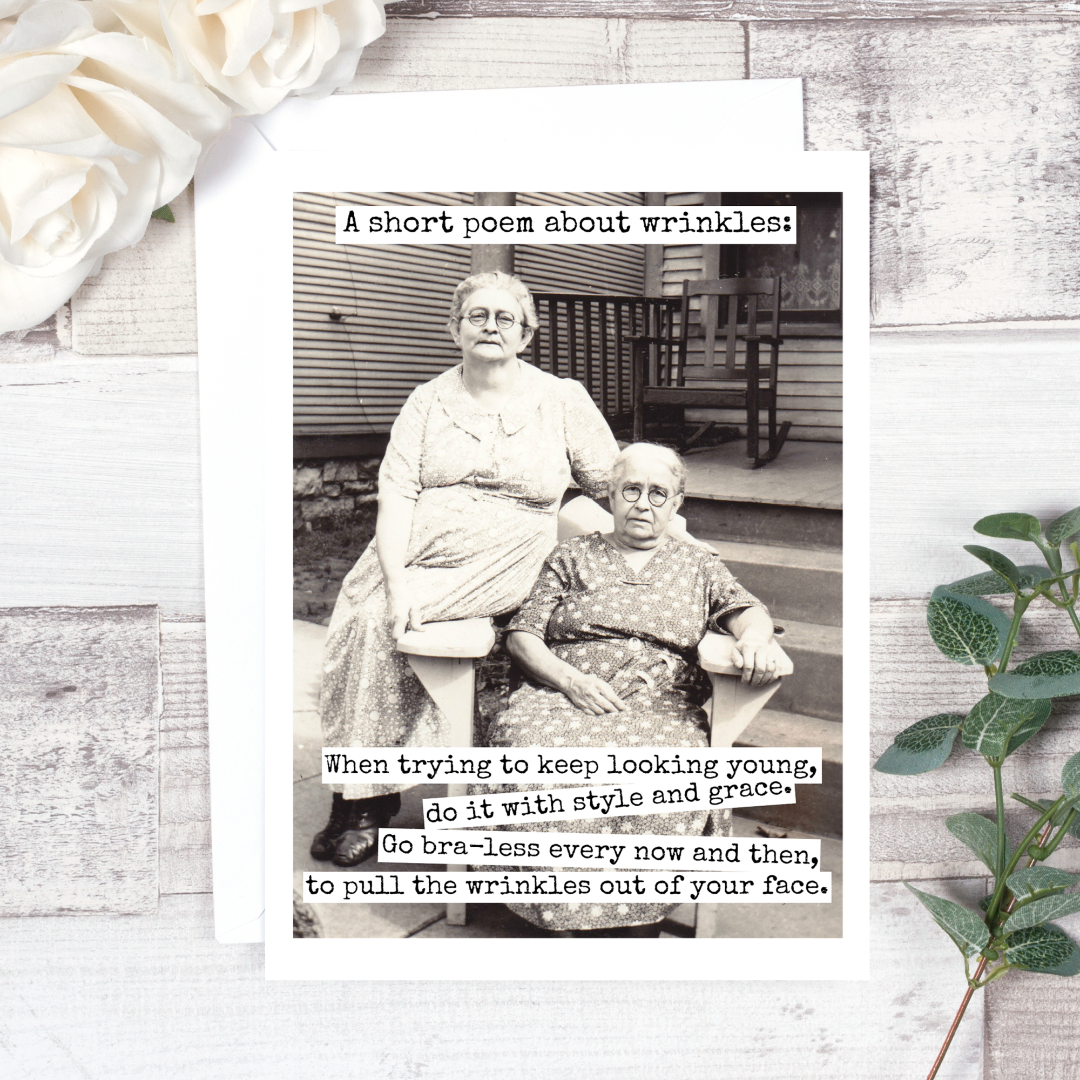 A Short Poem About Wrinkles Birthday Card: A vintage photo of two women on a greeting card that reads "A short poem about wrinkles: When trying to keep looking young, do it with style and grace. Go bra-less every now and then, to pull the wrinkles out of your face."