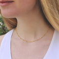 Woman wearing Vintage Acorn satellite ball chain necklace 