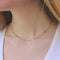 Woman wearing a gold rectangle chain necklace