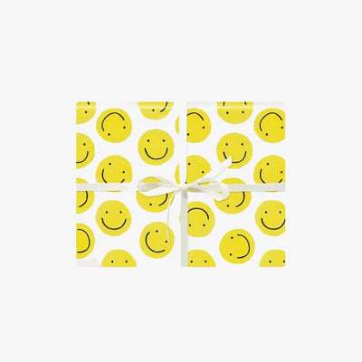 white gift wrap with yellow smiley faces all over
