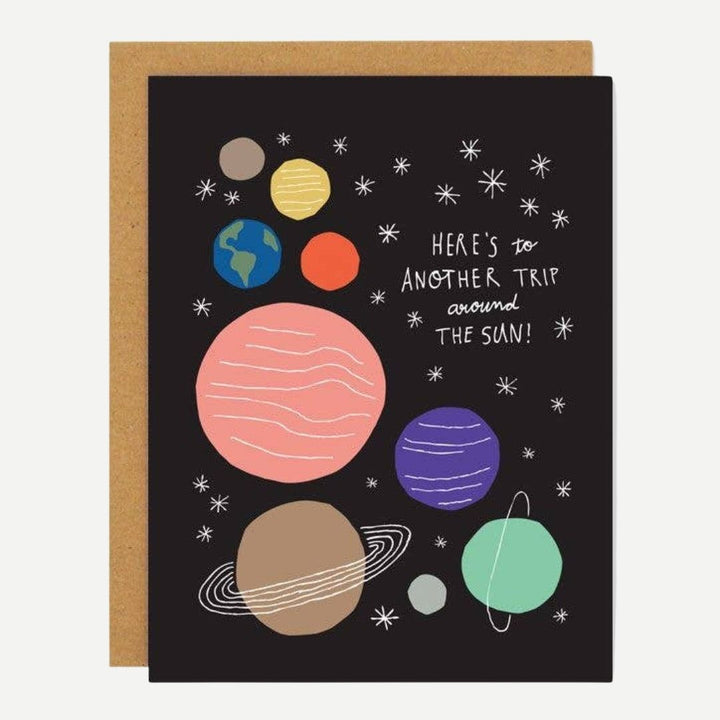 A black card with cartoon planets and the quote 