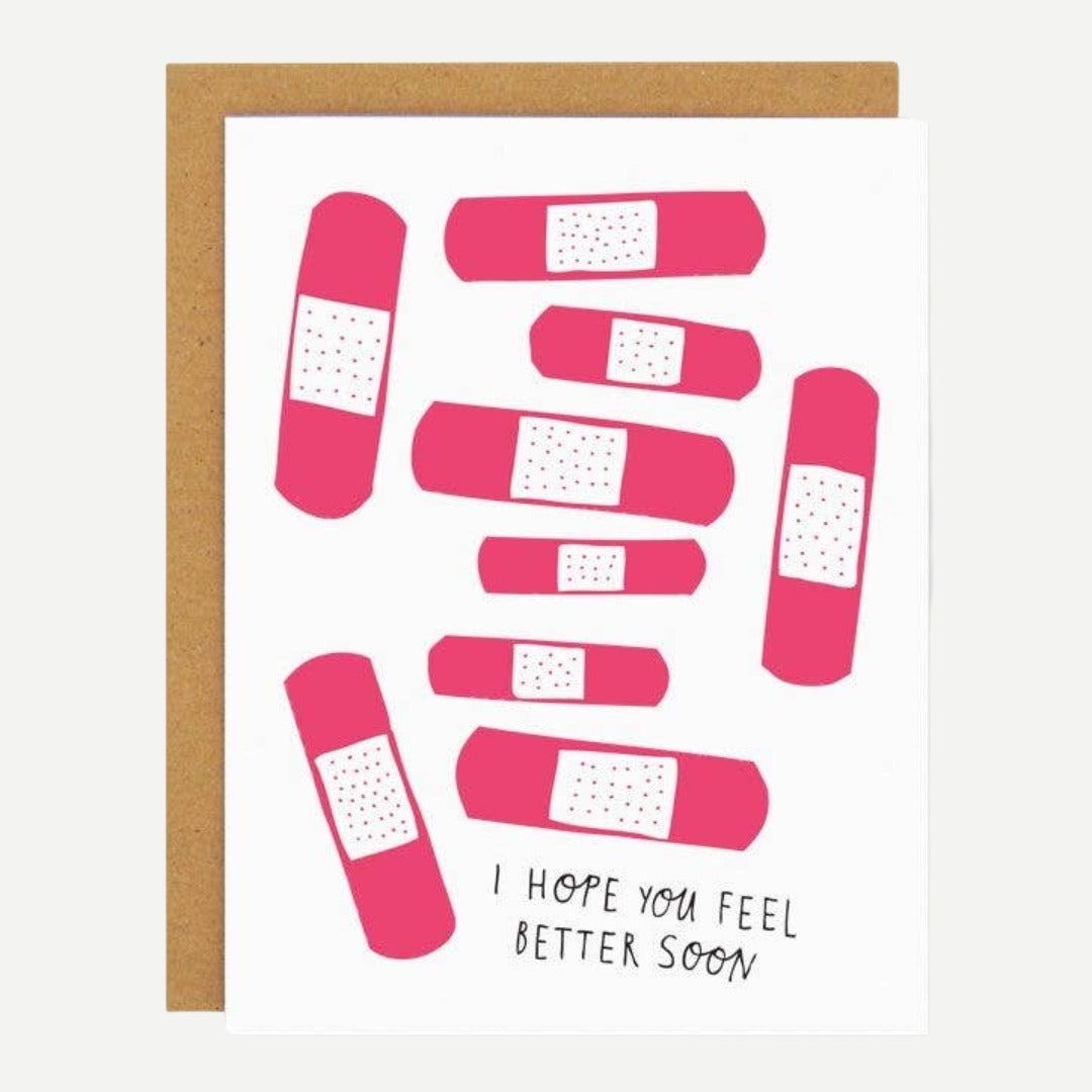 A white card with pink bandages and quote "I hope you feel better soon".