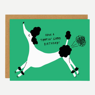A green card with a black and white poodle tooting and quote 