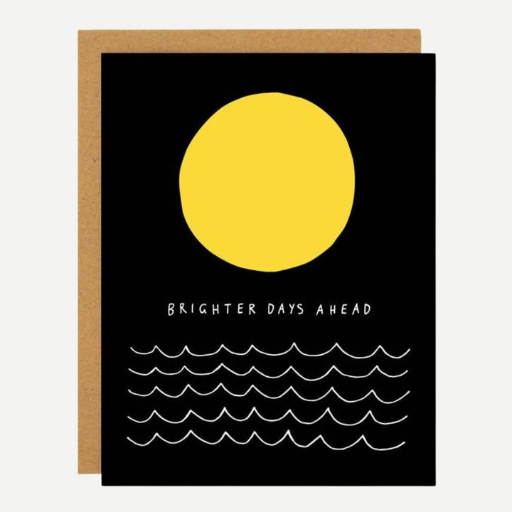 A black card with a yellow full moon and waves and reads brighter days ahead.