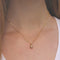 Woman Wearing Tiny Gold Acorn Necklace by Vintage Acorn